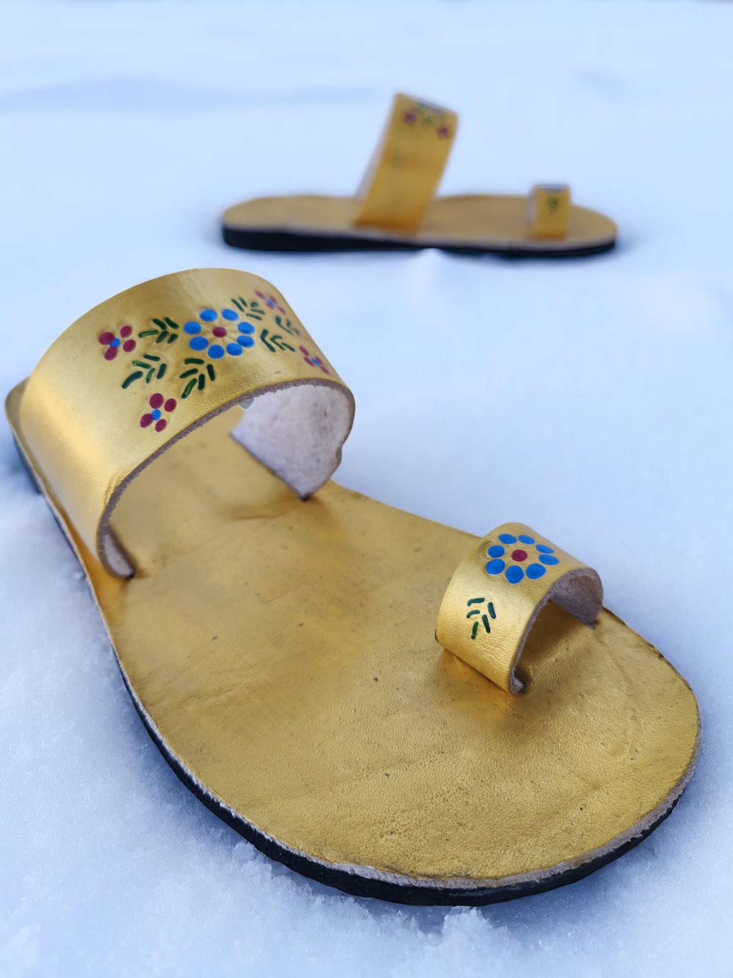 Gold color soft leather handmade toe-ring sandals with durable lightweight outsoles and hand-painted floral pattern