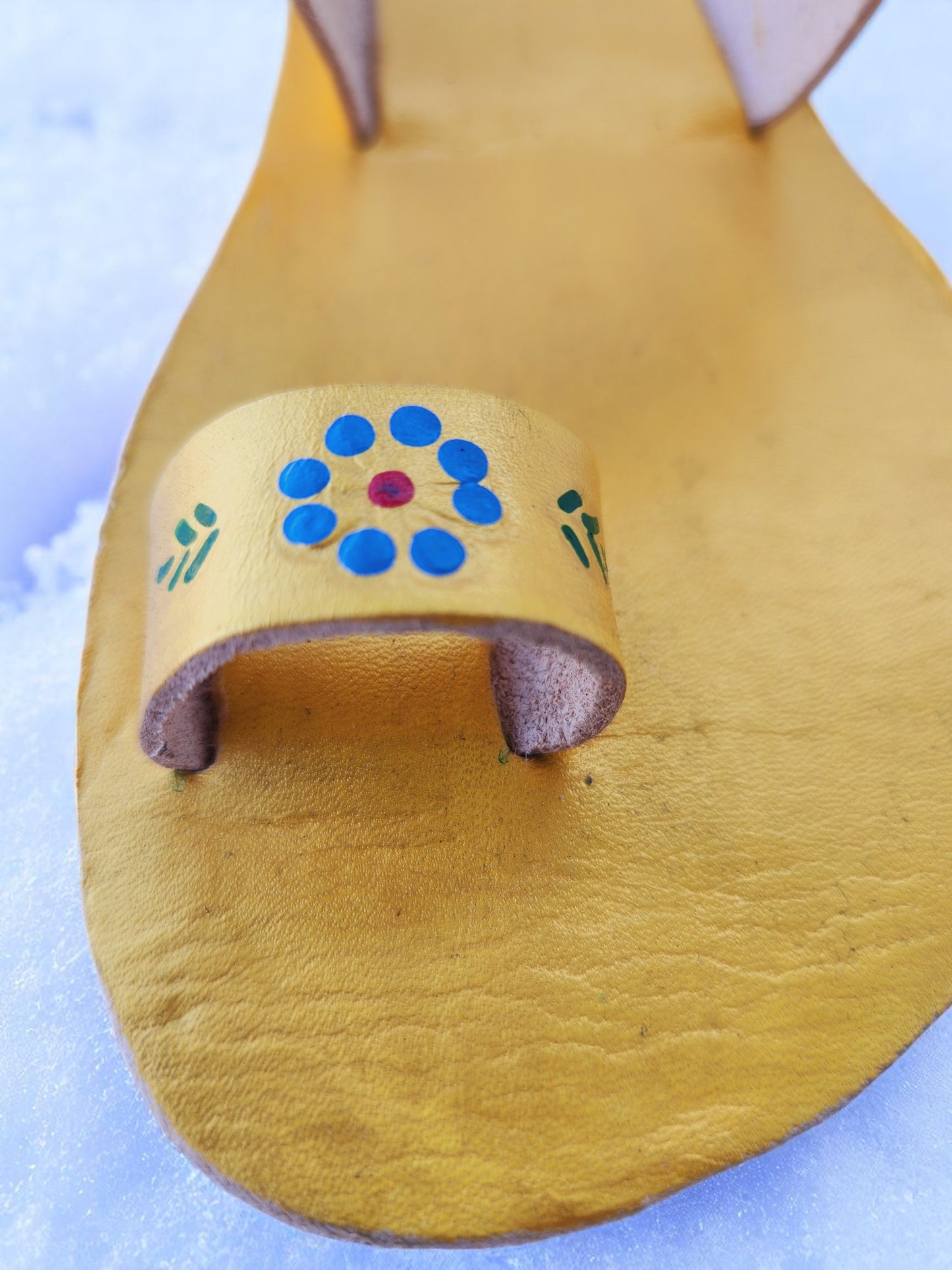 Gold color soft leather handmade toe-ring sandals with durable lightweight outsoles and hand-painted floral pattern