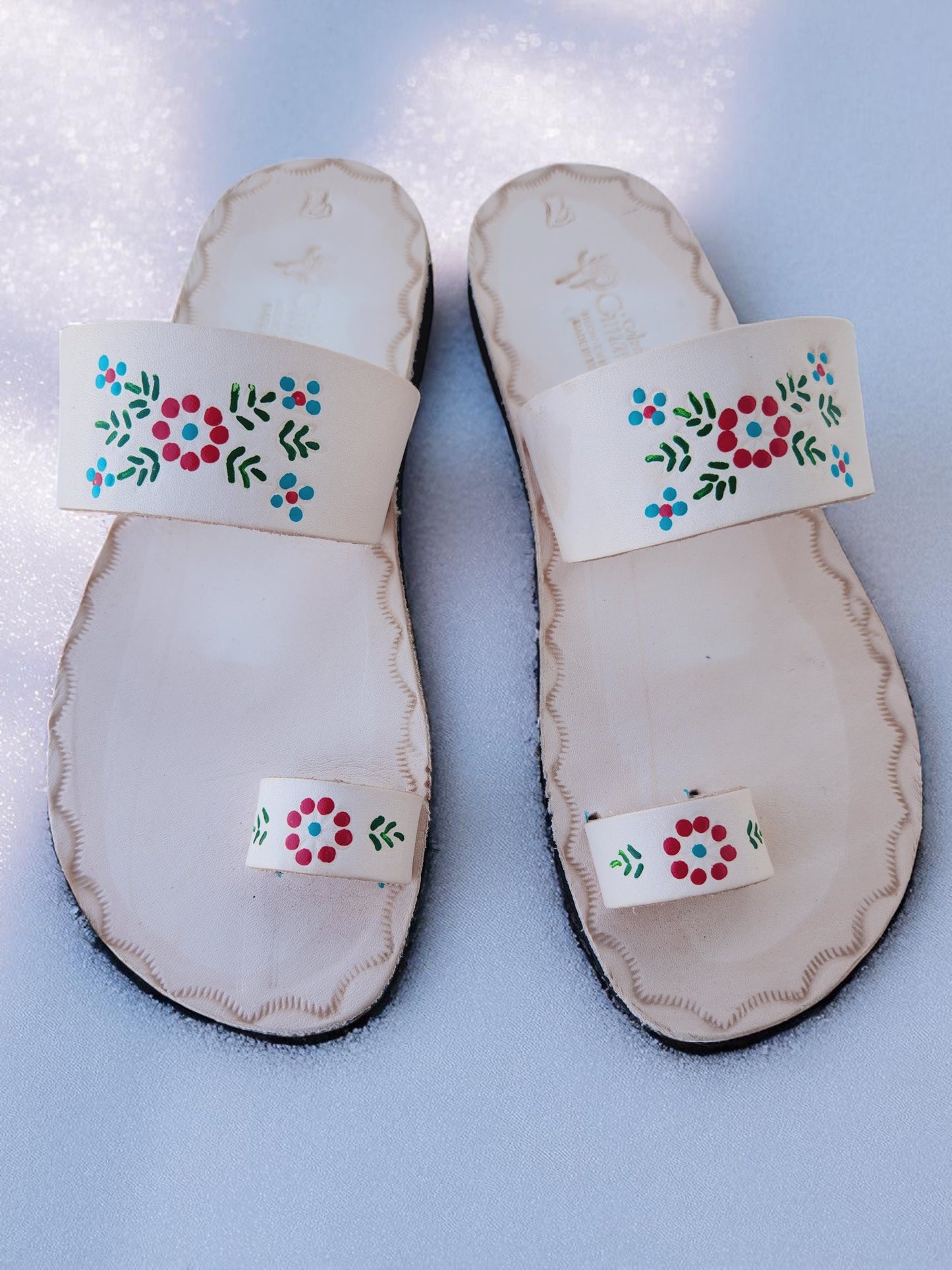 Beige soft leather handmade toe-ring sandals with durable lightweight outsoles and hand-painted floral pattern.