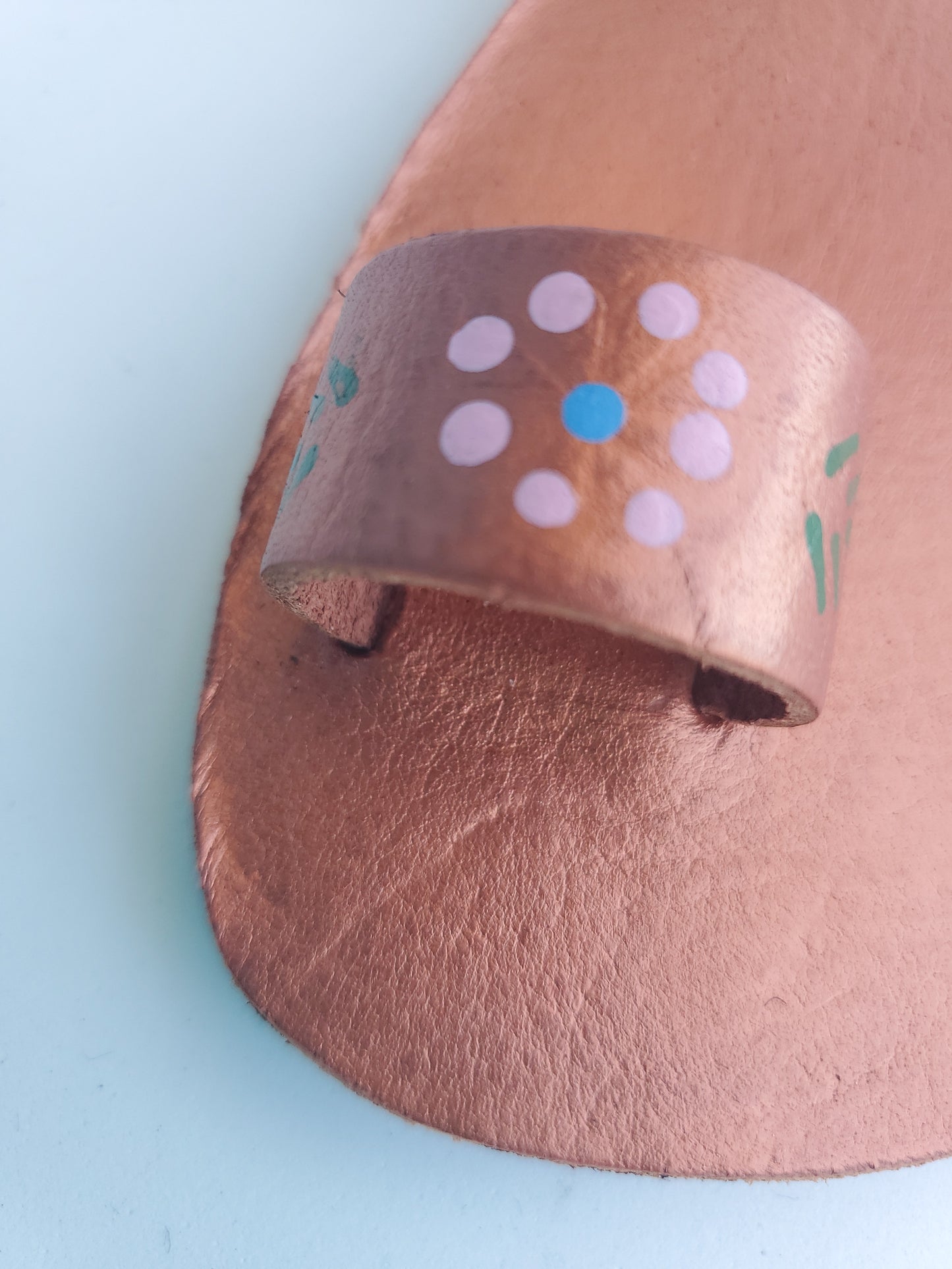 Copper color soft leather handmade toe-ring sandals with durable lightweight outsoles and hand-painted floral pattern