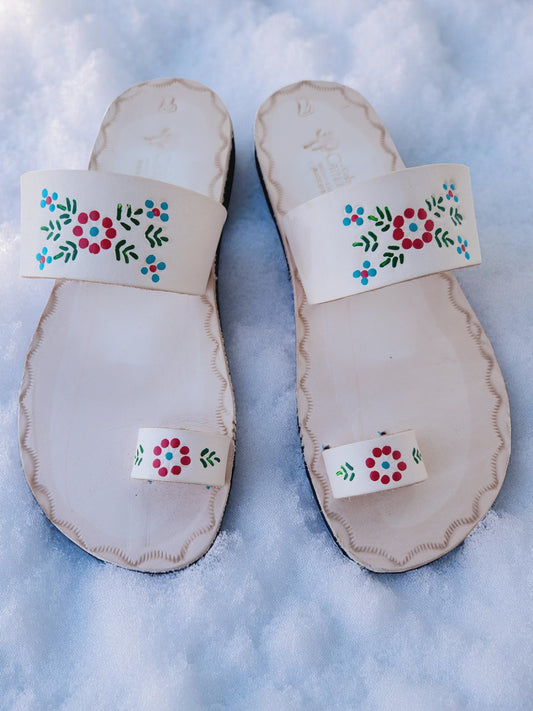 Beige soft leather handmade toe-ring sandals with  durable lightweight outsoles and hand-painted floral pattern.