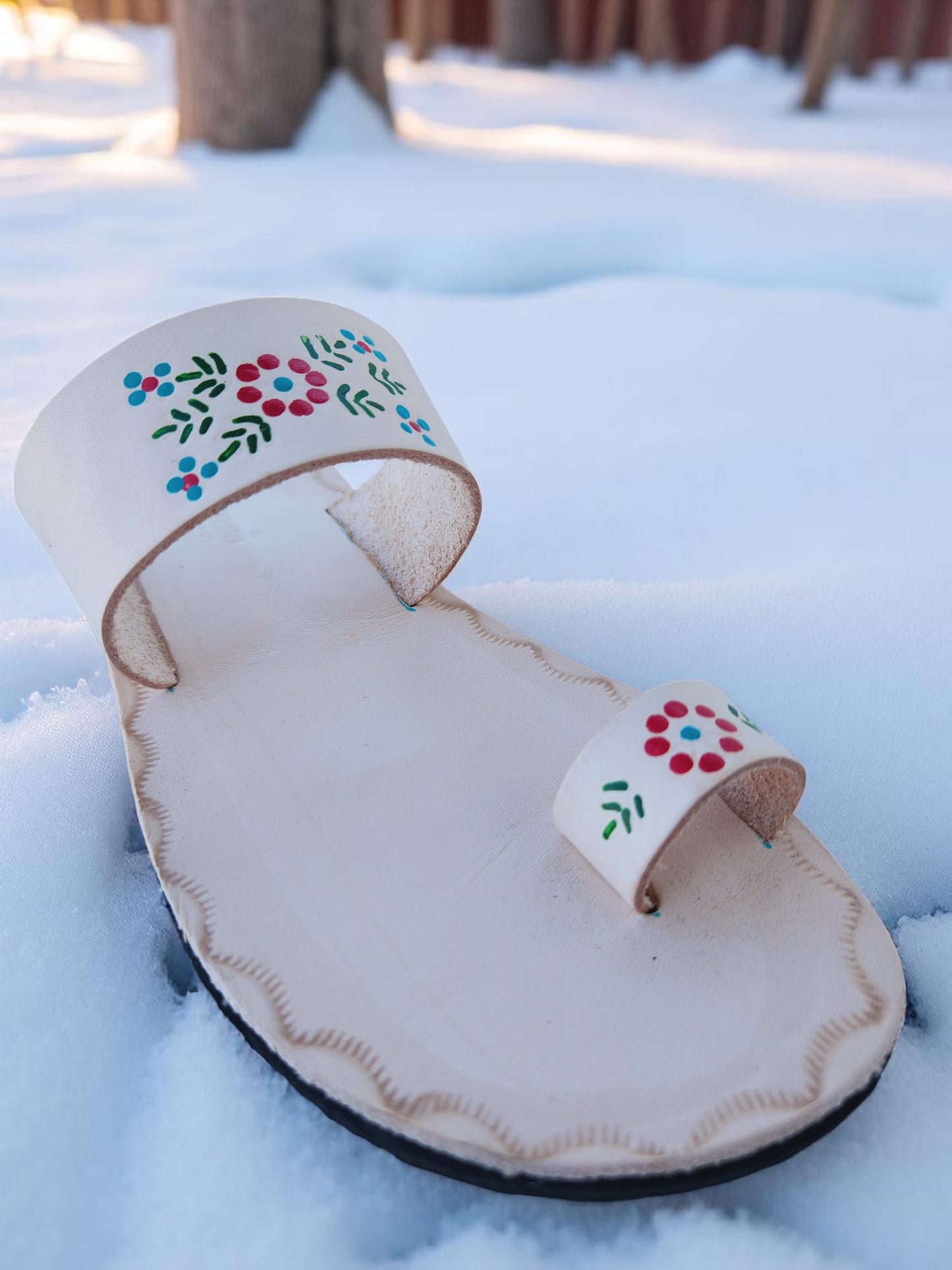 Beige soft leather handmade toe-ring sandals with  durable lightweight outsoles and hand-painted floral pattern.